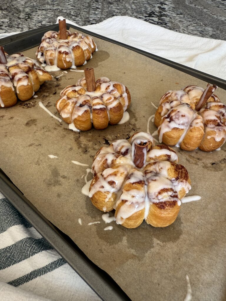 pumpkin shaped cinnamon rolls with cinnamon stick stems