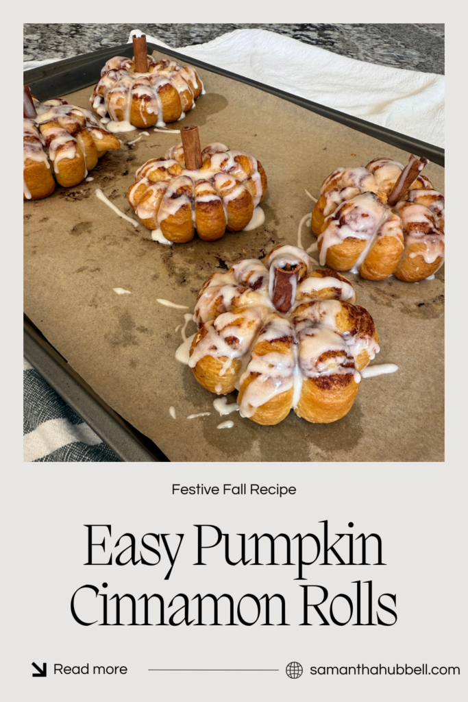 Cooked cinnamon rolls with a cinnamon stick stem are drizzled with icing.