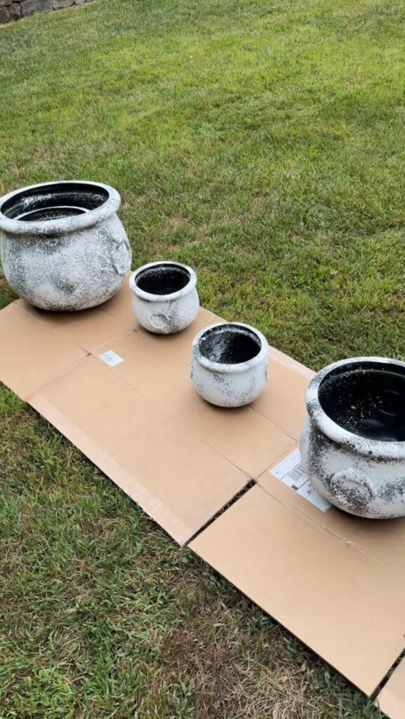 multiple sizes of plastic cauldrons covered in wall texture spray