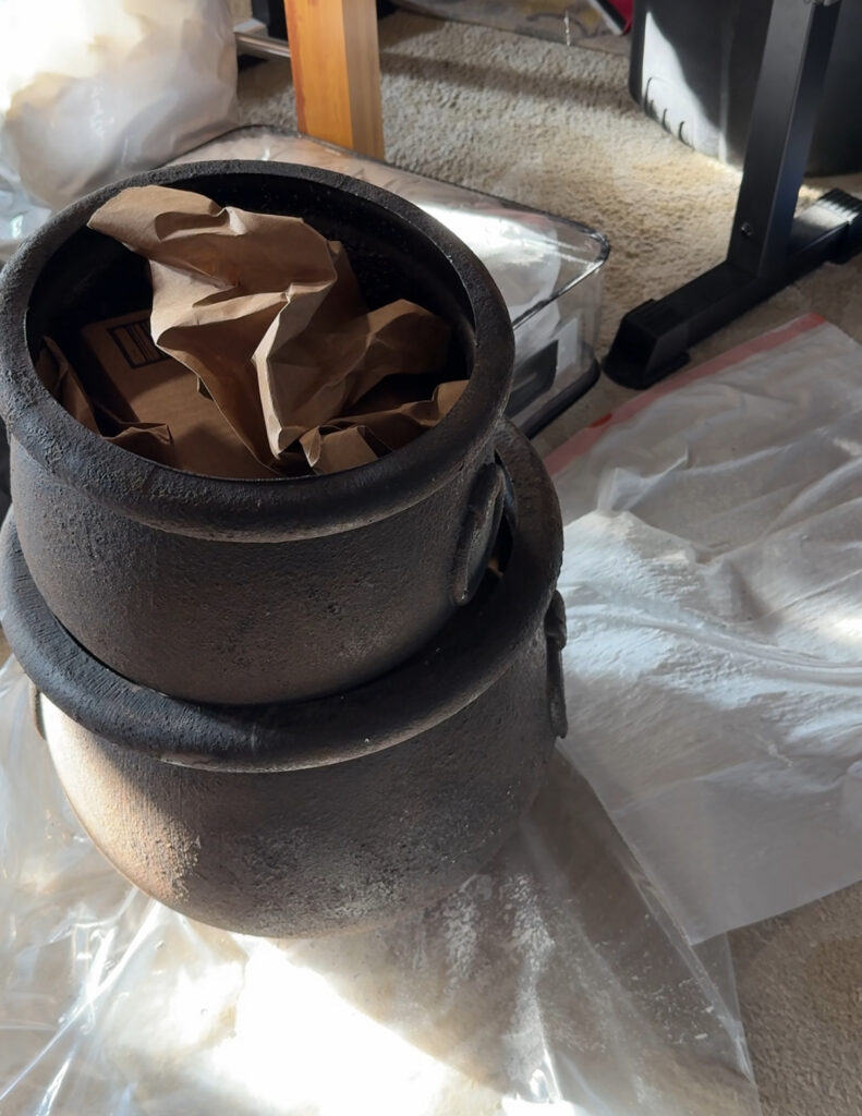fill plastic cauldrons with cardboard and paper before adding plastic ornaments as bubbles