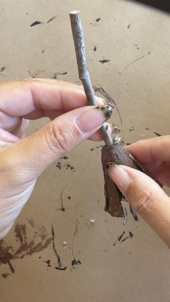 Use a small twig to make the witch broom handle