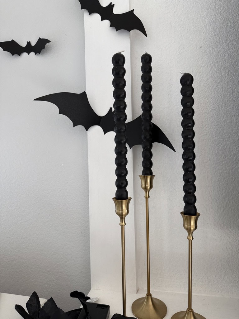 black taper candles and bat decals for Halloween